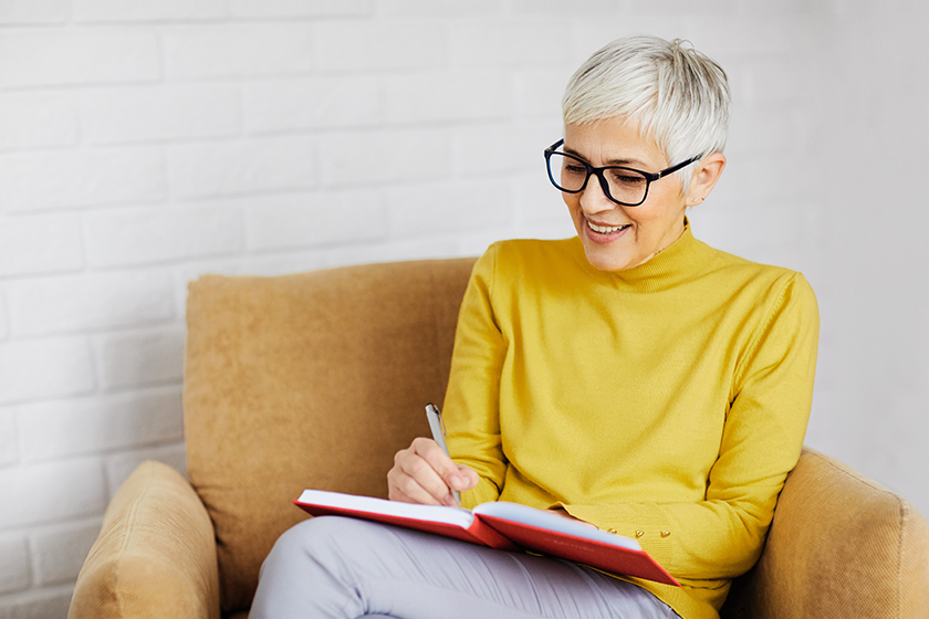 portrait beautiful senior woman writing notbook